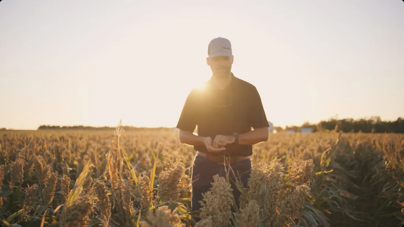 Cinematic golden-hour shot of a farmer in his field from a customer story