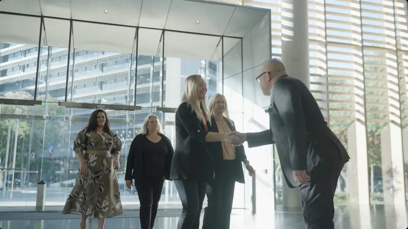 Business partners shaking hands in a bright lobby