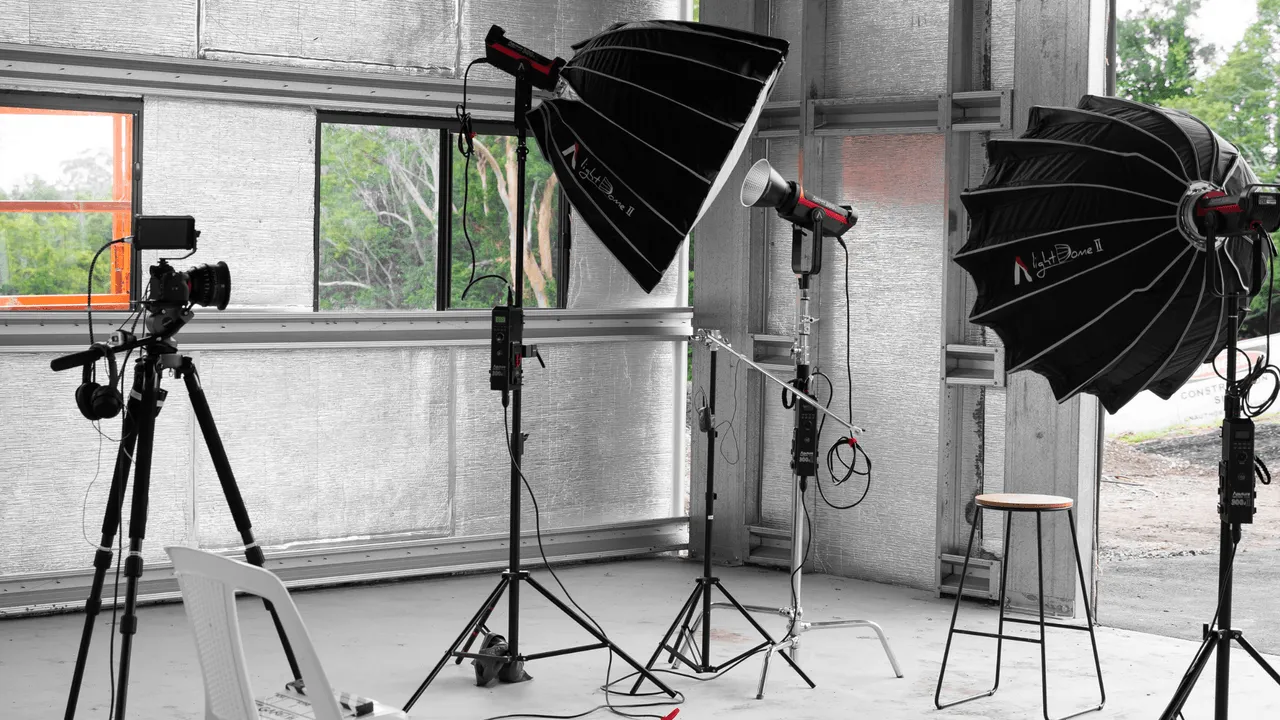 A professional interview studio with cameras, softboxes, and lighting equipment