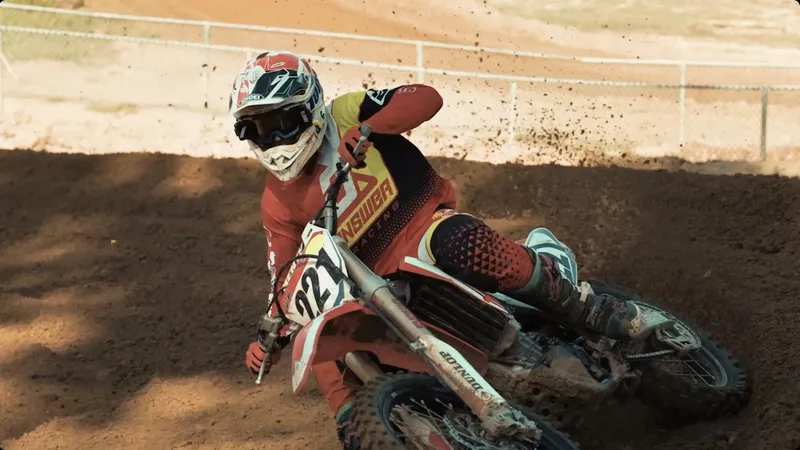 Motocross rider cornering hard in dynamic b-roll footage
